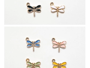 Close-up of colorful enamel dragonfly pendants with glitter finish for DIY jewelry