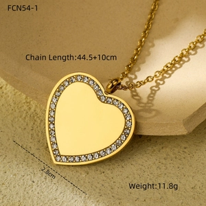 Detailed view of a gold heart pendant necklace with rhinestones and size measurements