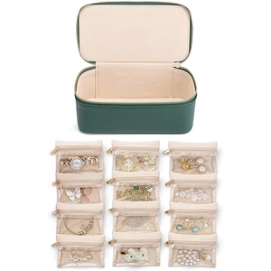Green leather travel jewelry organizer set with twelve beige transparent storage bags