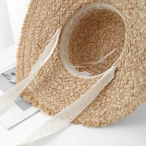 Women's summer straw hat with sweet bow, frayed edges and lace ribbon for sun protection