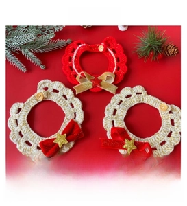 Macro shot of handmade crochet Christmas pet collar with red bow and gold star detail