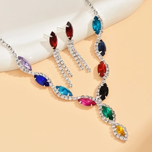 Macro detail of rainbow rhinestone bridal jewelry set with marquise cut crystals