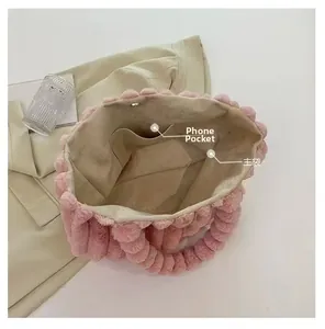 Interior view of pink plush tote bag showing main compartment and mobile phone pocket
