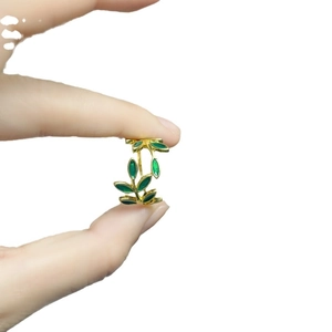 Elegant gold open ring featuring green enamel leaf design for a fresh stylish look