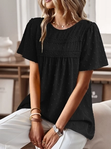 Detail of black short sleeve top featuring floral lace patchwork and jacquard fabric texture