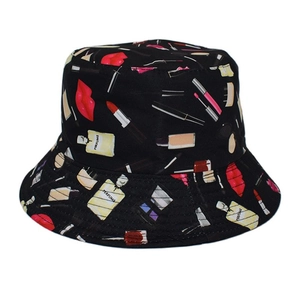 Detail of black canvas bucket hat with fashion cosmetics and perfume bottle prints