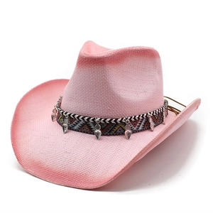Pink gradient straw cowboy hat with ethnic pendants and geometric band on white background