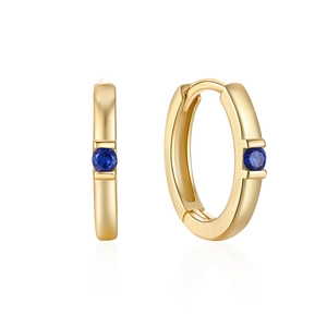Detail of gold hoop earrings with single blue gemstone in minimalist hinged design