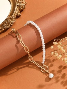 Detail of vintage gold chain and white pearl necklace with OT toggle clasp and pearl pendant