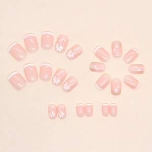 Short square pink press-on nails with white French tips and floral star designs