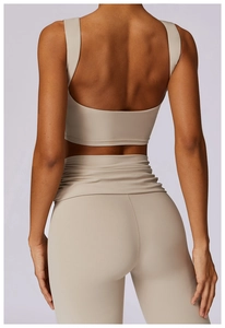 Rear view of sand beige yoga set featuring backless sports bra and high-waist leggings