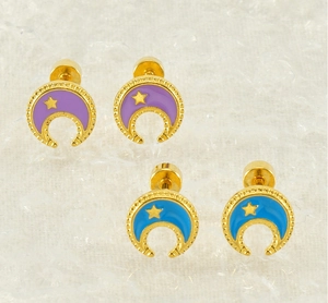 Detail of 18k gold plated moon and star stud earrings with purple and blue enamel finish