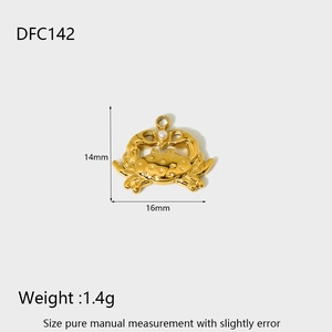 Macro view of gold crab pendant with pearl inlay showing 14mm by 16mm dimensions