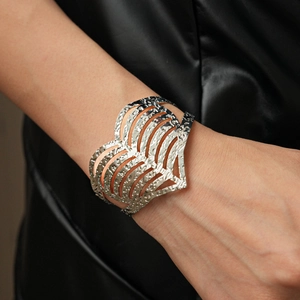 Detail view of a hammered silver heart cuff bracelet with parallel cutout lines