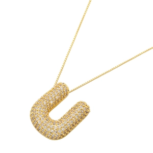 Detailed view of capital letter U pendant with micro-paved cubic zirconia and box chain