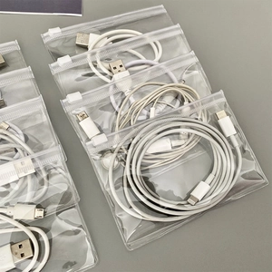 Detailed top view of clear PVC storage bags with USB-C and Lightning cables inside