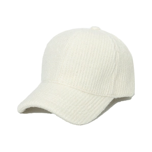 Detail view of the thick knit cream baseball cap featuring high-quality fabric texture