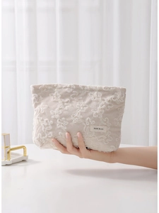 Beige corduroy makeup bag with 3D floral lace embroidery and a secure zipper closure