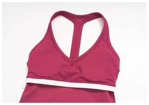 Detail of dark red racerback yoga vest showing V-neckline and white elastic band