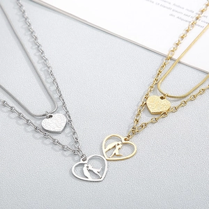 Double-layer necklace featuring a heart and kissing couple silhouette pendant in gold and silver