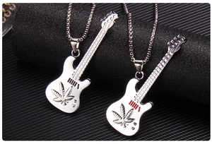 Macro shot of silver electric guitar pendants featuring a cannabis leaf design on black