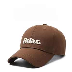 Close-up of brown cotton baseball cap with white Relax embroidery and curved brim