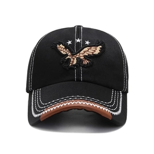 Black baseball cap with eagle embroidery, white stitching, and brown leather brim trim