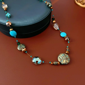Detail of beaded necklace with turquoise, crystal accents and vintage metal beads