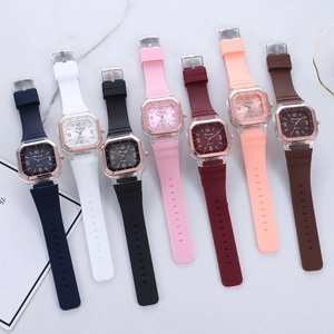 Flat lay of multiple minimalist square quartz watches with colorful silicone straps