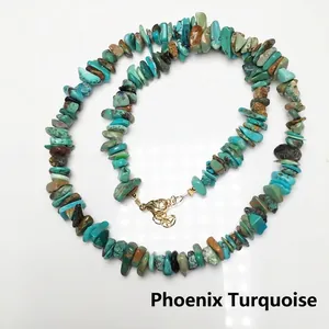 Natural Phoenix Turquoise chip stone necklace with a golden lobster clasp on white background