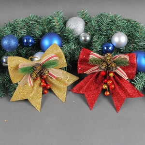 Golden and red Christmas bows with pine cones and berries for festive tree decorations