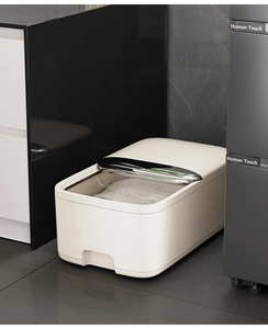 Modern cream rice dispenser with transparent lid showing storage grains in minimalist kitchen