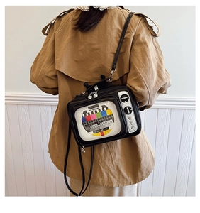 Detail of retro television-shaped crossbody bag featuring a color test signal screen