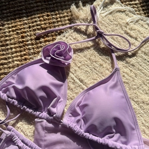 Detail of lavender bikini with handmade 3D floral accent on the shoulder strap