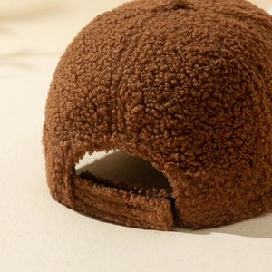 Detail view of the brown teddy fleece baseball cap with adjustable rear strap buckle