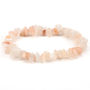 Macro shot of irregular natural pale orange stone beads on an elastic stretch bracelet