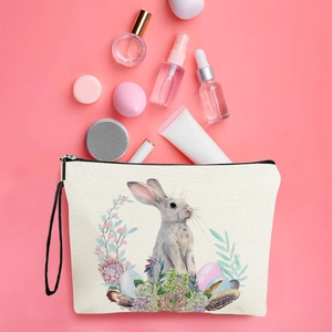 Easter canvas makeup bag with rabbit and floral wreath on a soft pink background