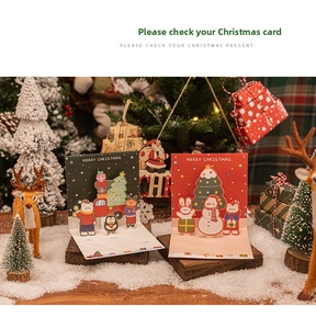 3D pop-up Christmas card featuring cute cartoon snowman and reindeer forest design
