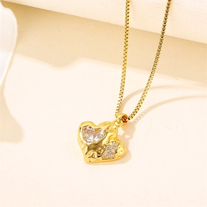 18k gold plated stainless steel heart necklace with cubic zirconia on beige background
