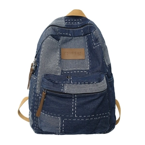 Retro denim patchwork backpack with blue denim fabric and contrast white stitching details