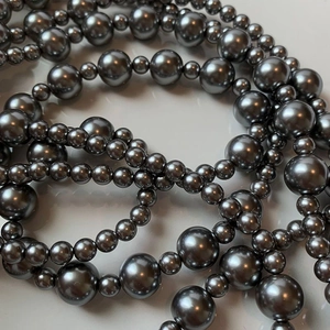 Detailed view of dark grey multi-layer pearl necklace with lustrous polished beads