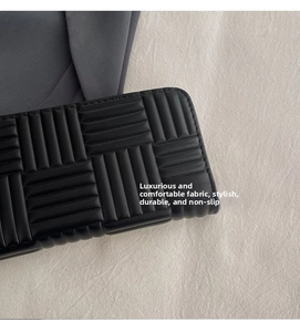 Close-up of black leather long wallet with embossed geometric texture and durable finish