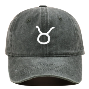 Detailed view of white Taurus zodiac embroidery on washed cotton baseball cap