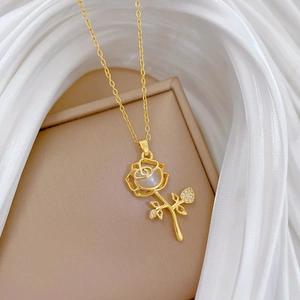 Macro shot of gold floral necklace featuring opal-like petals and sparkling zircon leaves