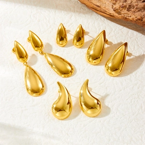 Polished gold-plated stainless steel teardrop and heart fringe earrings on a white background