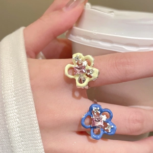 Summer enamel flower open ring with pink crystal center stone worn by a model