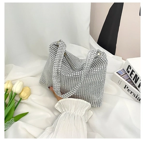 Close-up of sparkling silver rhinestone evening bag with elegant crescent shape