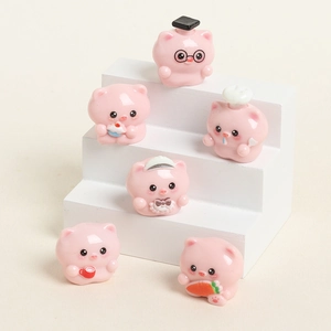 Set of 6 cute pink resin pig figurines in various outfits on a white tiered display stand