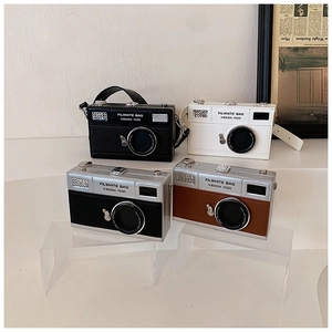 Detailed view of vintage camera-shaped crossbody bags in four premium color variants