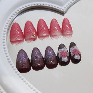 Handmade press-on nails with 3D floral relief, pink gradient, and pearl accents